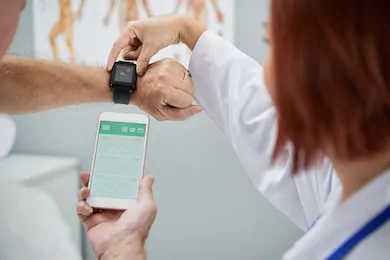 Provider helping patient with smartwatch
