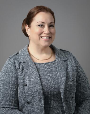 Photo of woman in business attire smiling