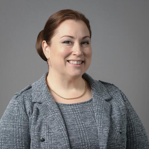 Photo of woman in business attire smiling